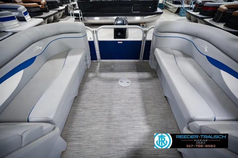 Slide: The Image of Interior of a 2021 Bennington 22 SVSR pontoon boat with gray seating and blue accents. - 21