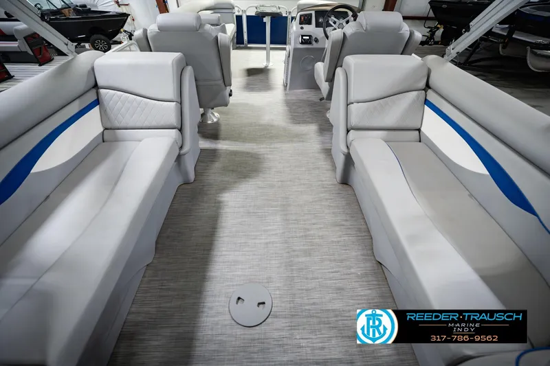 Slide: The Image of 2021 Bennington 22 SVSR pontoon boat interior with gray seating and blue accents. - 22