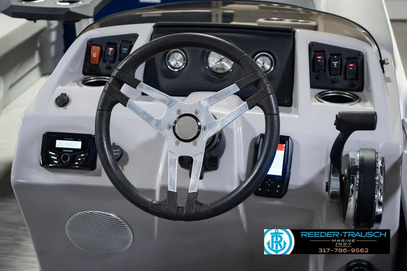 Slide: The Image of 2021 Bennington 22 SVSR boat dashboard with steering wheel and control panel. - 35