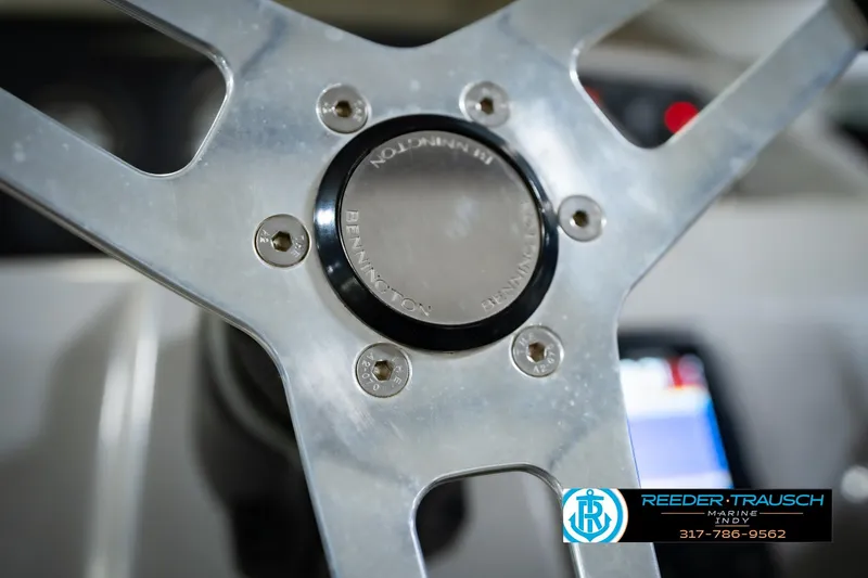 Slide: The Image of Steering wheel of a 2021 Bennington 22 SVSR boat, featuring Reeder-Trausch Marine logo. - 37