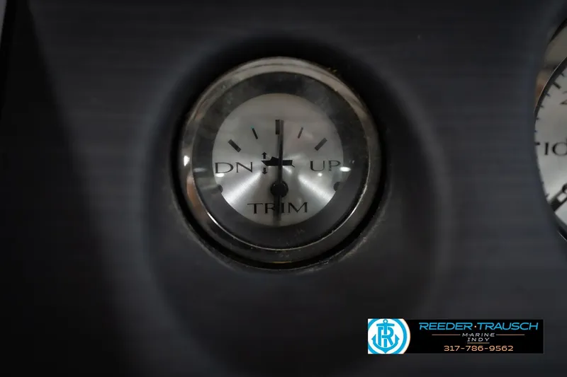 Slide: The Image of Close-up of a 2021 Bennington 22 SVSR trim gauge, showing "DN" and "UP" indicators. - 40