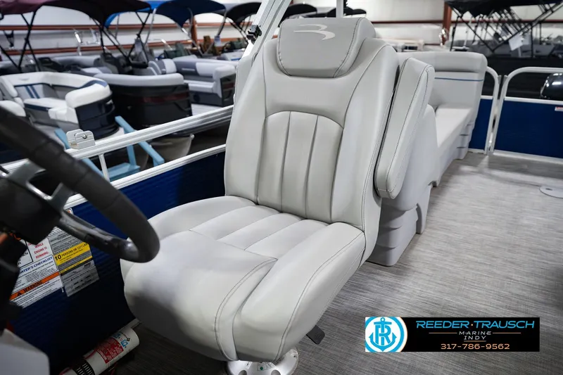 Slide: The Image of 2021 Bennington 22 SVSR boat interior with plush captain's chair and steering wheel. - 46