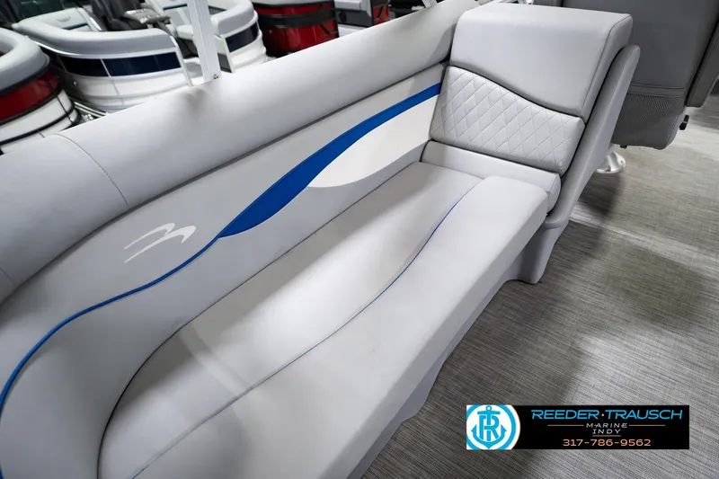 Slide: The Image of 2021 Bennington 22 SVSR boat interior seating with blue accents and quilted design. - 50