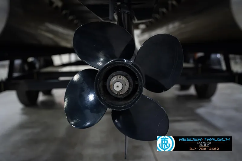 Slide: The Image of Close-up of a 2021 Bennington 22 SVSR boat propeller in a showroom setting. - 58