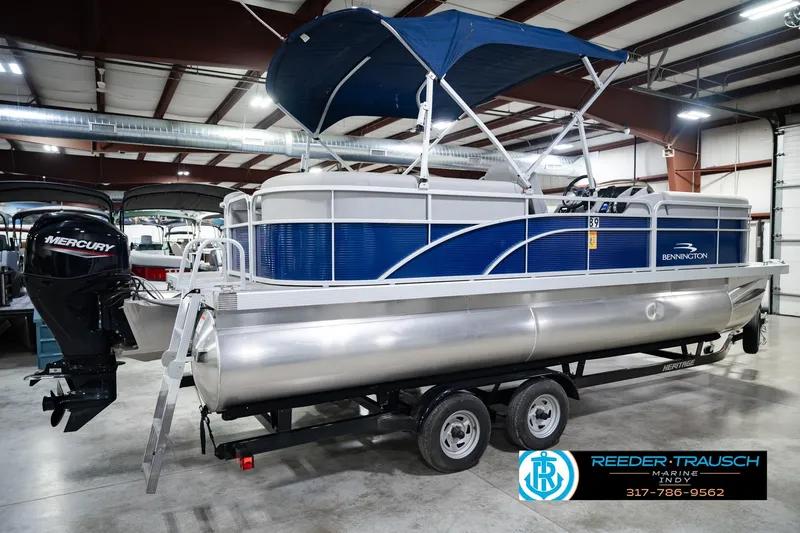 Slide: The Image of 2021 Bennington 22 SVSR pontoon boat with Mercury engine in indoor showroom. - 8