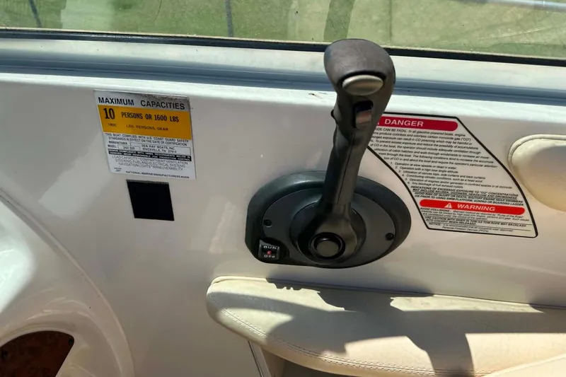 Slide: The Image of Control panel of a 2001 Sea Ray 260 Bow Rider boat with capacity warning. - 10