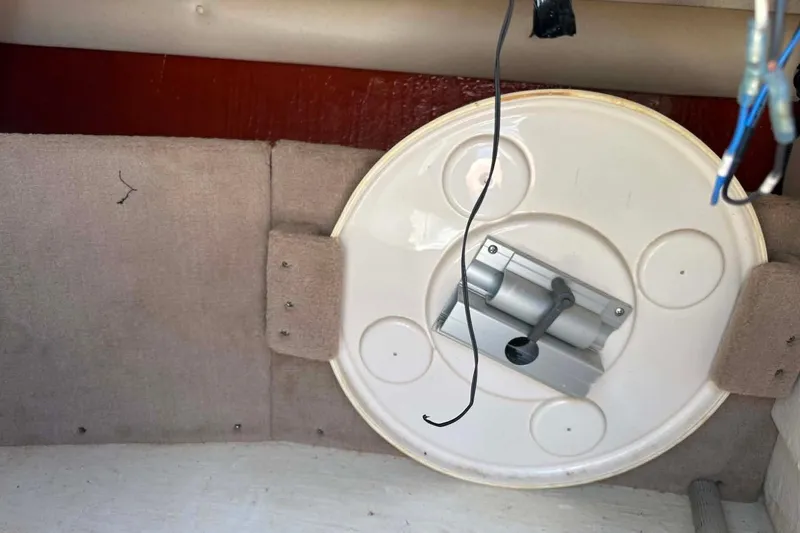 Slide: The Image of Interior view of a 2001 Sea Ray 260 Bow Rider boat, featuring a mounted circular fixture. - 12