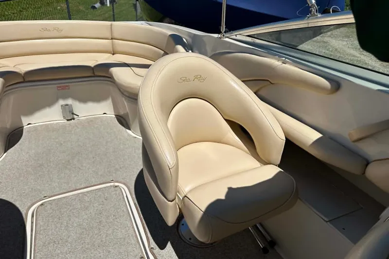 Slide: The Image of Interior of a 2001 Sea Ray 260 Bow Rider with beige seating and carpeted floor. - 26