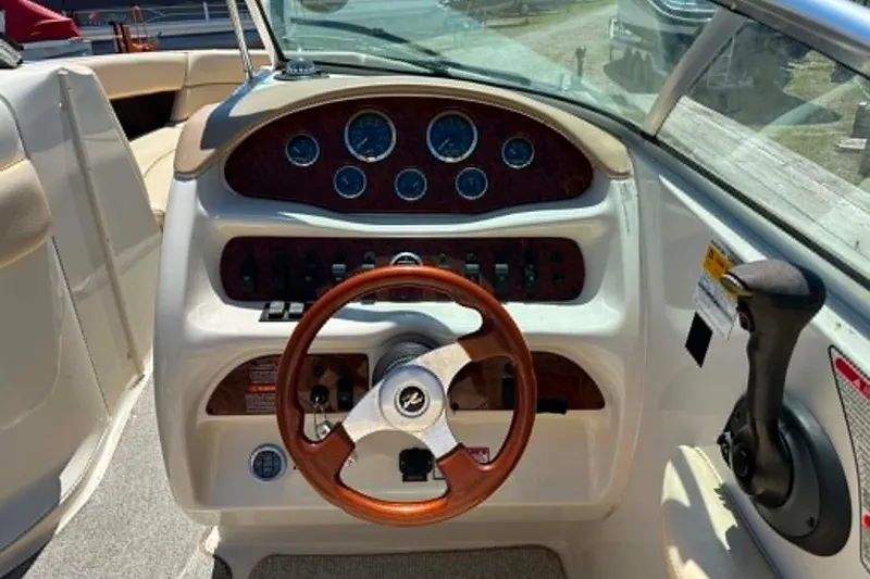 Slide: The Image of 2001 Sea Ray 260 Bow Rider dashboard with wooden steering wheel and instrument panel. - 27