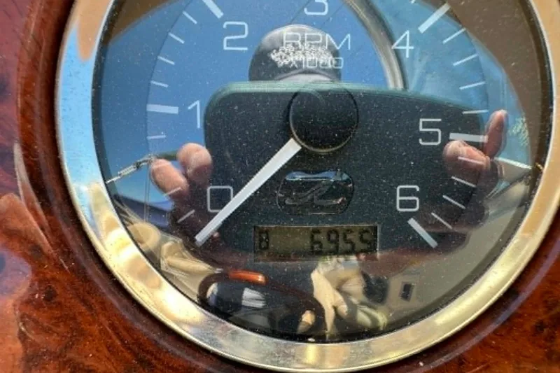 Slide: The Image of Close-up of a 2001 Sea Ray 260 Bow Rider tachometer displaying 695.9 hours. - 7