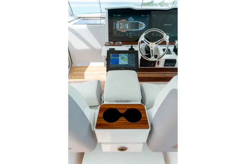 Slide: The Image of 2026 Regal 43 SAV yacht helm with modern navigation displays and luxurious seating. - 16