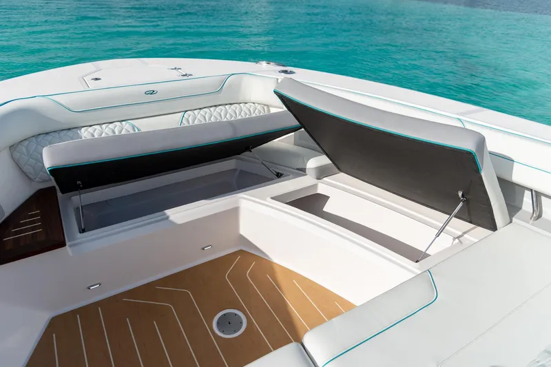 Slide: The Image of Luxurious 2026 Regal 43 SAV boat interior with open storage compartments, on turquoise water. - 20