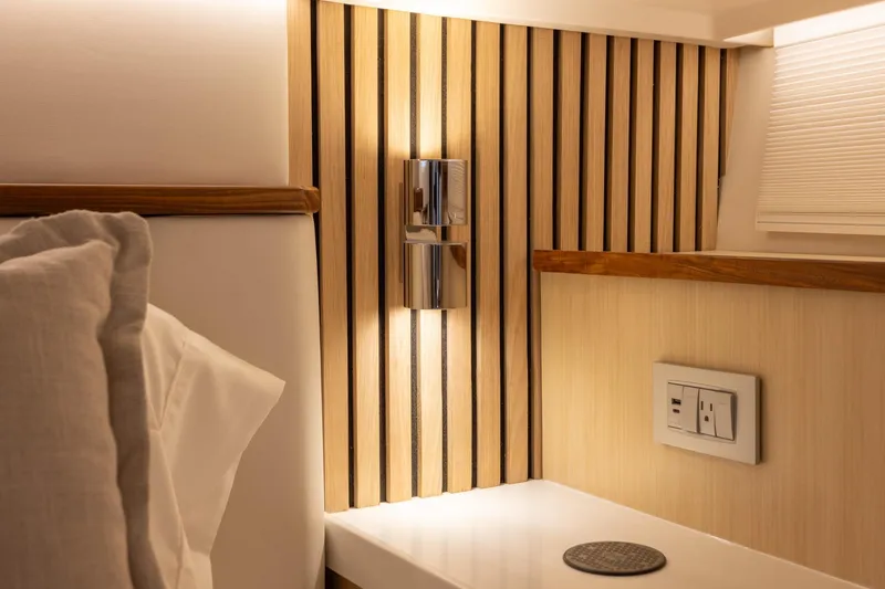 Slide: The Image of Luxurious interior of 2026 Regal 43 SAV yacht with modern lighting and wood paneling. - 27