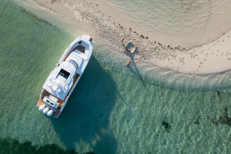 Slide: The Image of Aerial view of 2026 Regal 43 SAV yacht anchored near a sandy beach. - 5