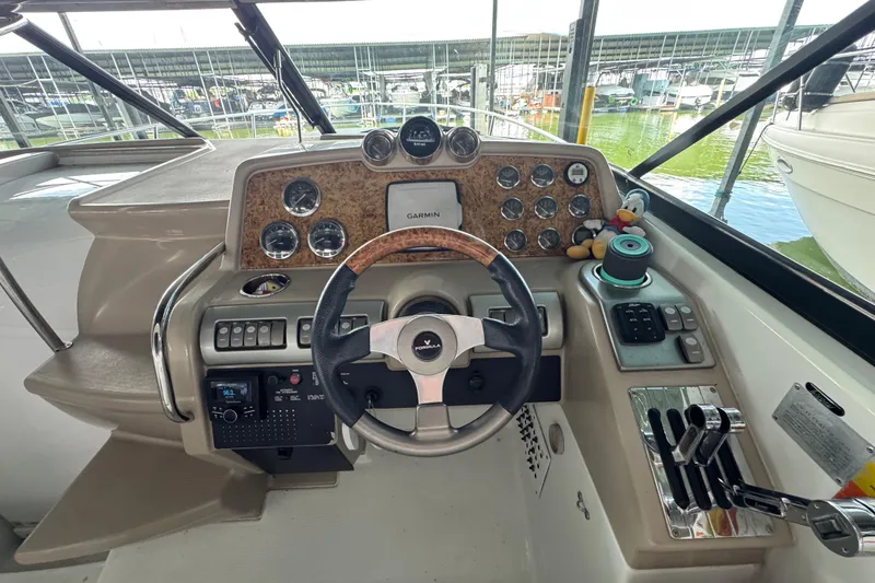 Slide: The Image of 2008 Formula 350 Sun Sport boat dashboard with steering wheel and control panel. - 14