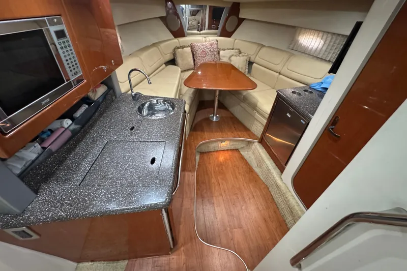 Slide: The Image of Interior of a 2008 Formula 350 Sun Sport boat with kitchen and seating area. - 16