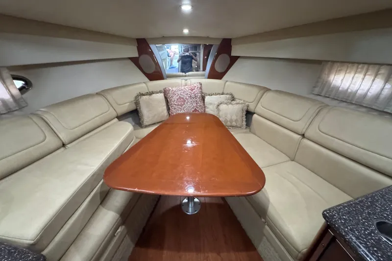 Slide: The Image of Interior of 2008 Formula 350 Sun Sport with beige seating and wooden table. - 17