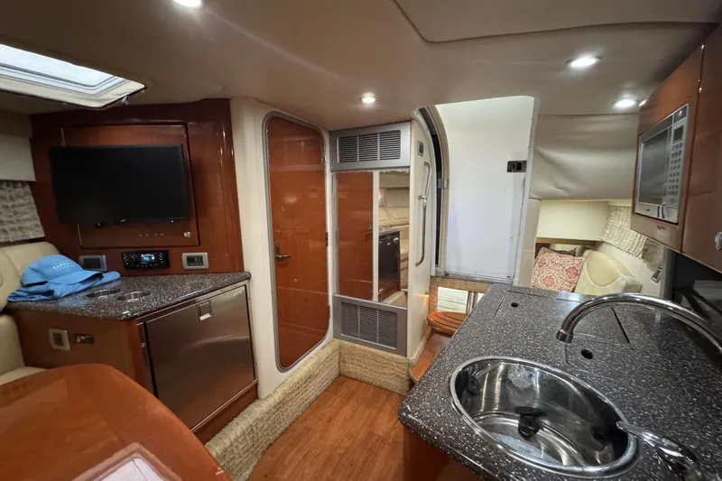 Slide: The Image of Interior of 2008 Formula 350 Sun Sport boat with kitchenette and seating area. - 19