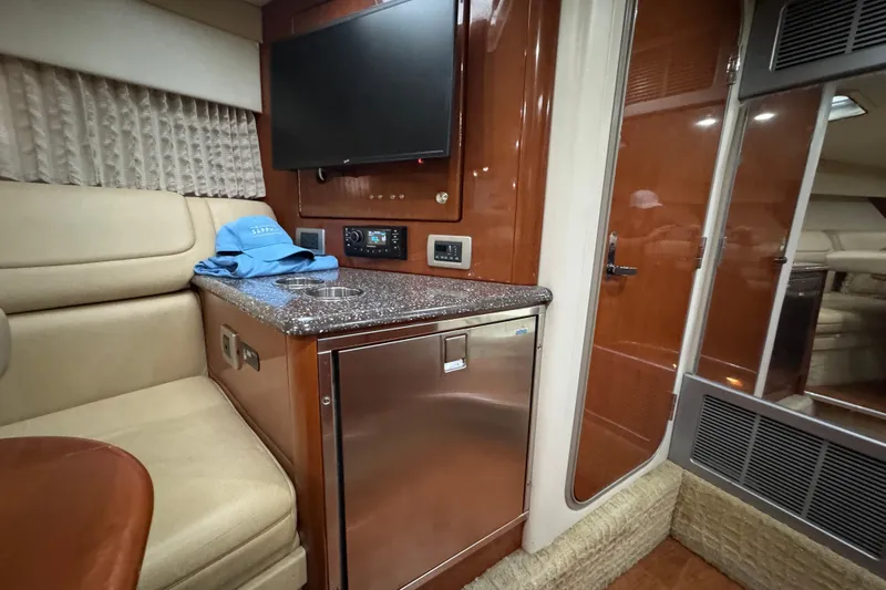 Slide: The Image of Interior of 2008 Formula 350 Sun Sport boat with seating, TV, and mini-fridge. - 20