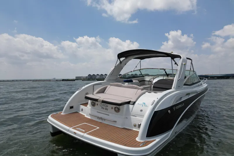 Slide: The Image of 2008 Formula 350 Sun Sport boat on water under a partly cloudy sky. - 5
