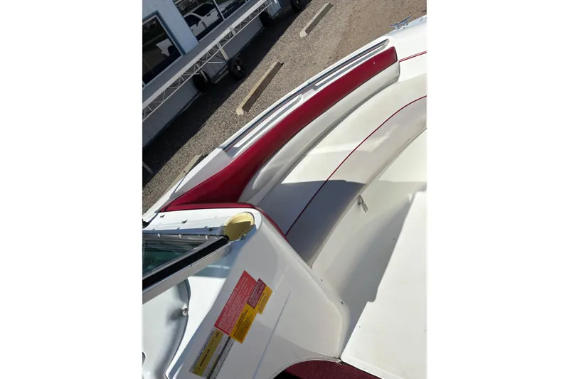 Slide: The Image of 1993 Larson SEi 200 Cuddy I/O boat interior with red and white seating. - 10