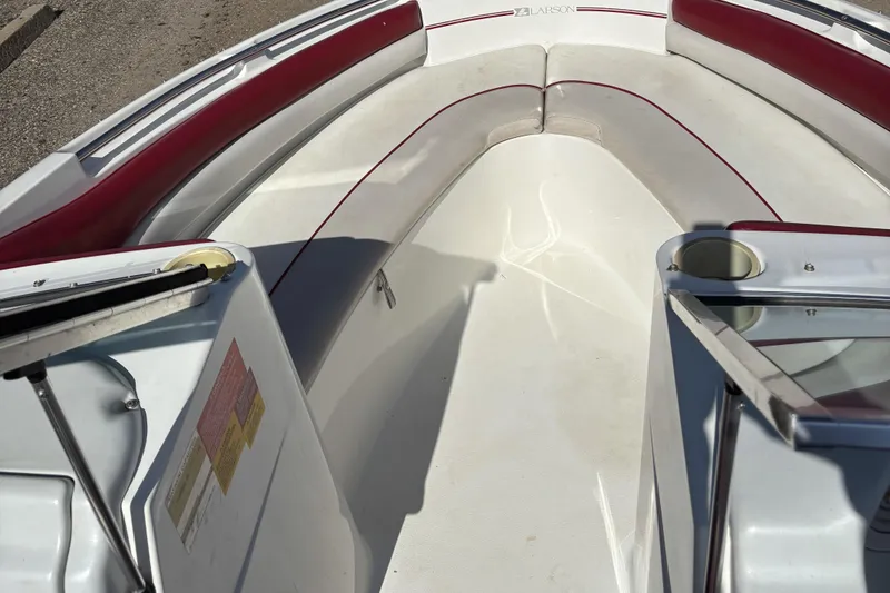 Slide: The Image of 1993 Larson SEi 200 Cuddy I/O boat interior with red and white seating. - 13