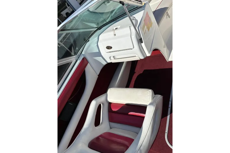 Slide: The Image of Interior of a 1993 Larson SEi 200 Cuddy I/O boat with red and white seating. - 14