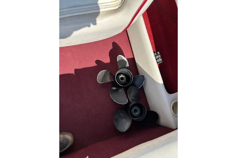 Slide: The Image of Propellers on red carpet inside 1993 Larson SEi 200 Cuddy I/O boat. - 16