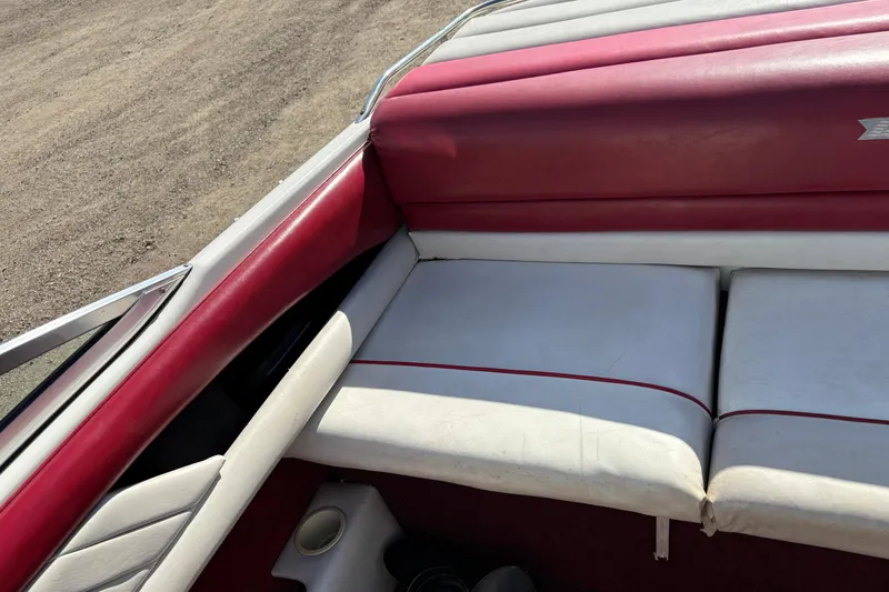 Slide: The Image of Interior of a 1993 Larson SEi 200 Cuddy I/O boat with red and white seating. - 17