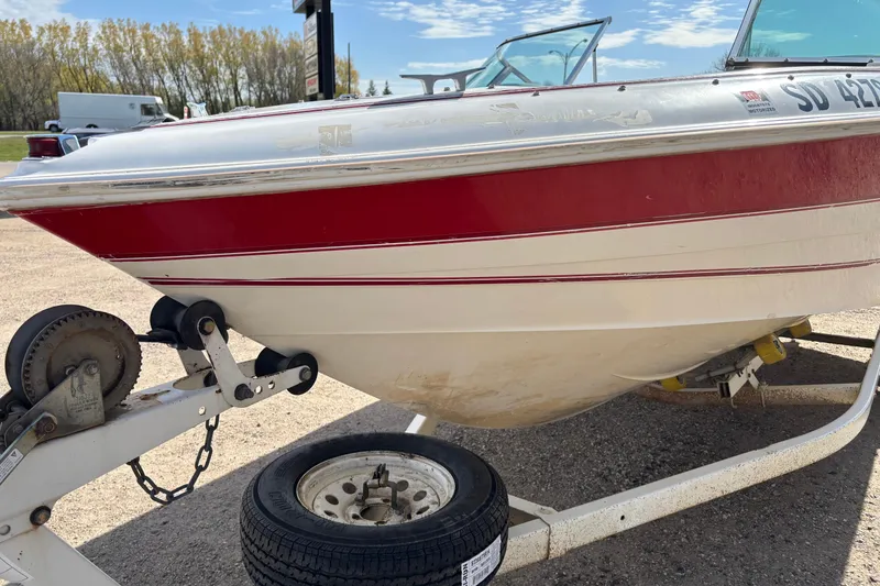 Slide: The Image of 1993 Larson SEi 200 Cuddy I/O boat on trailer, red and white exterior. - 2