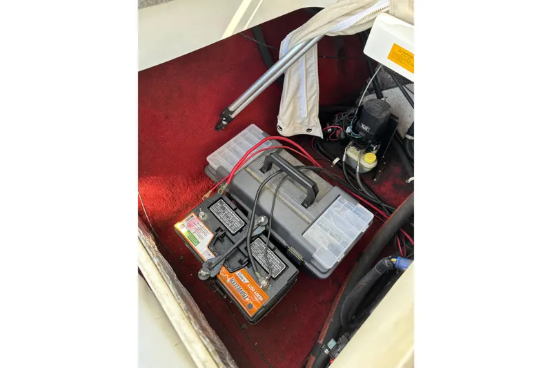 Slide: The Image of Battery compartment of a 1993 Larson SEi 200 Cuddy I/O boat with red carpeting. - 20