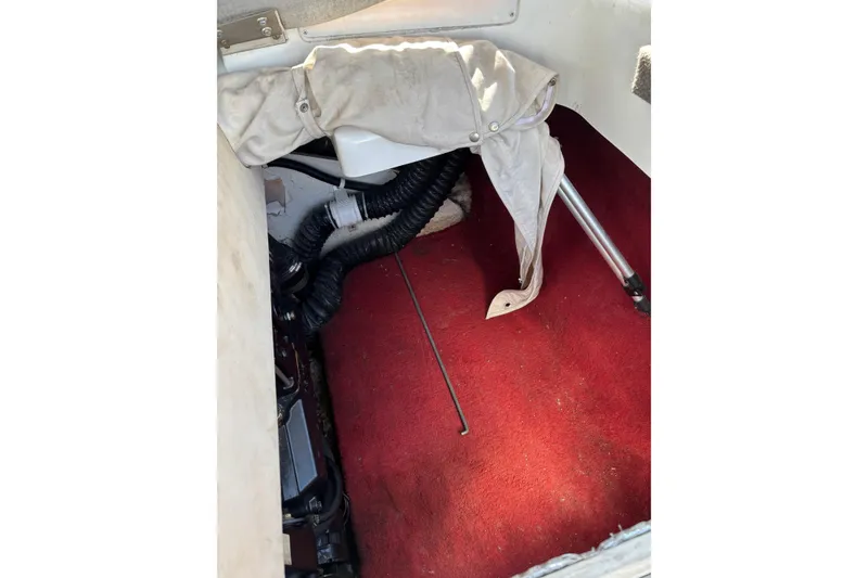 Slide: The Image of Interior of 1993 Larson SEi 200 Cuddy I/O boat with red carpet and equipment. - 21