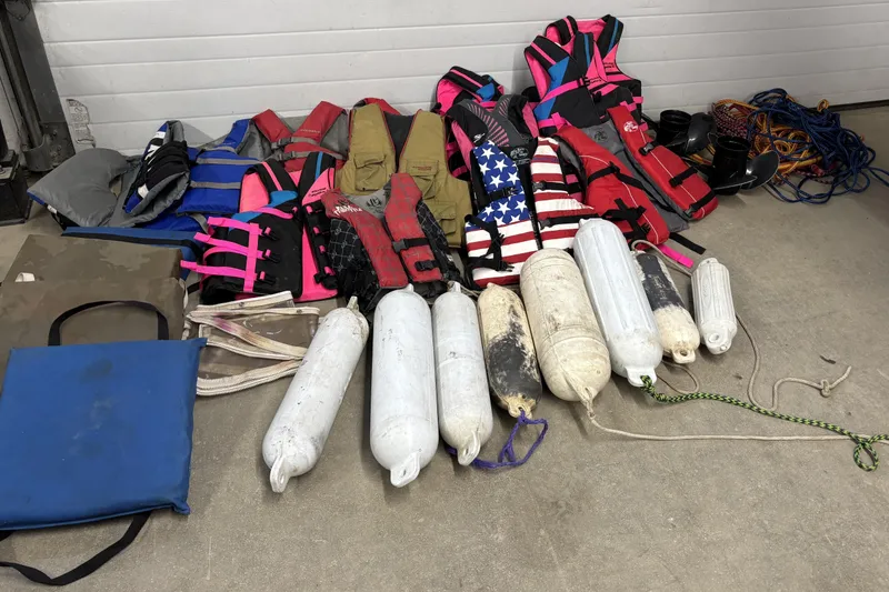 Slide: The Image of Assorted life jackets, boat fenders, and ropes for a 1993 Larson SEi 200 Cuddy I/O. - 26