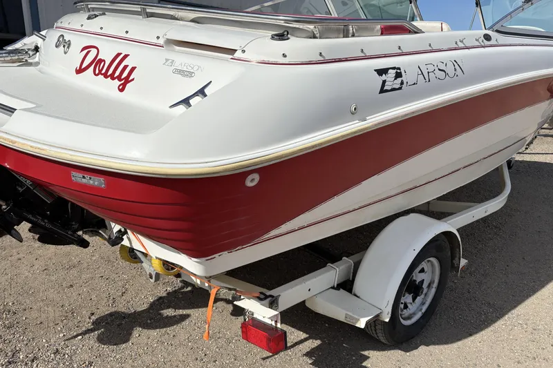 Slide: The Image of 1993 Larson SEi 200 Cuddy I/O boat with red and white exterior on trailer. - 6