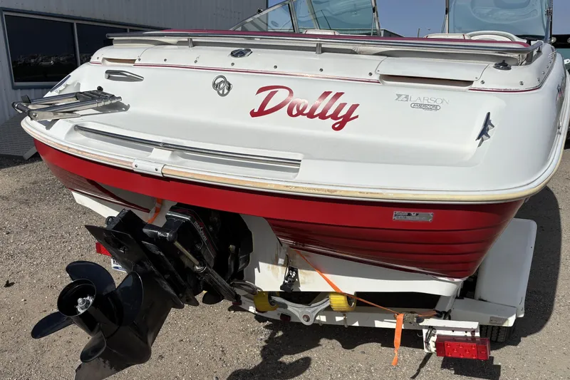 Slide: The Image of 1993 Larson SEi 200 Cuddy I/O boat with red and white exterior, named "Dolly." - 7