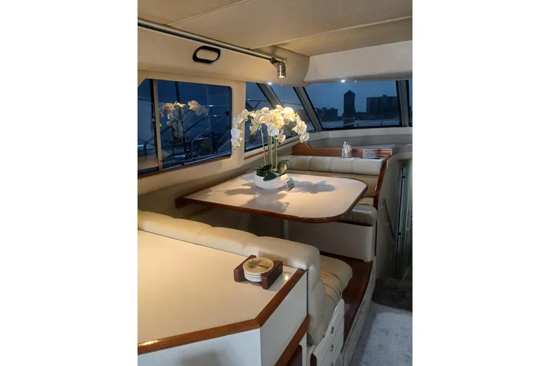 Slide: The Image of Luxurious interior of 1996 Sea Ray 550 Sedan Bridge yacht with elegant dining area. - 6