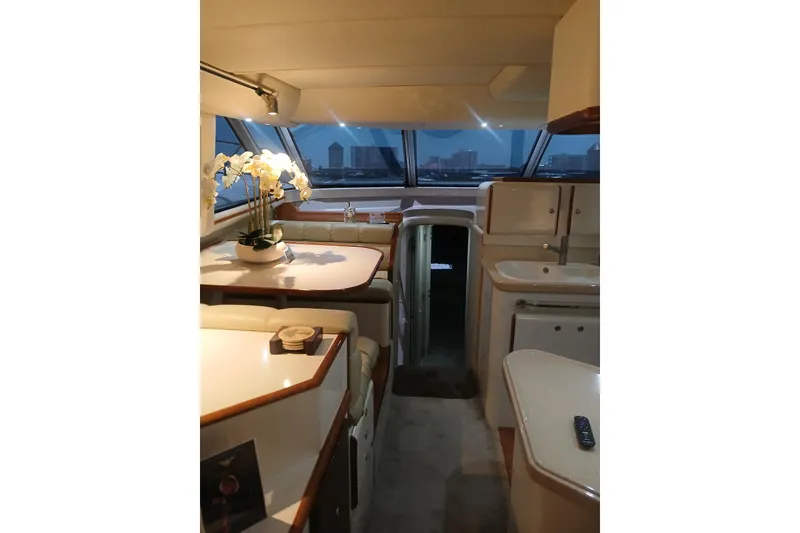 Slide: The Image of Luxurious interior of 1996 Sea Ray 550 Sedan Bridge yacht with elegant dining area. - 7