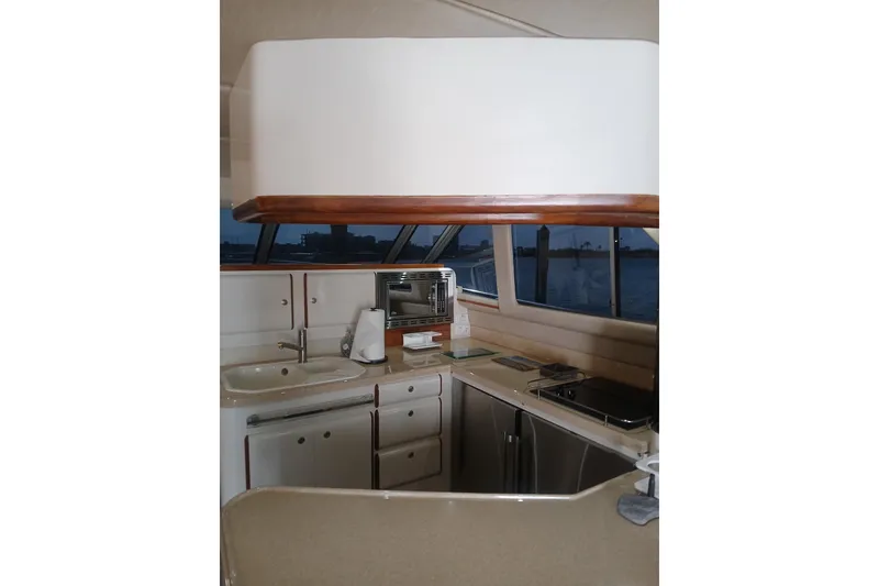 Slide: The Image of Interior view of 1996 Sea Ray 550 Sedan Bridge yacht kitchen area. - 8
