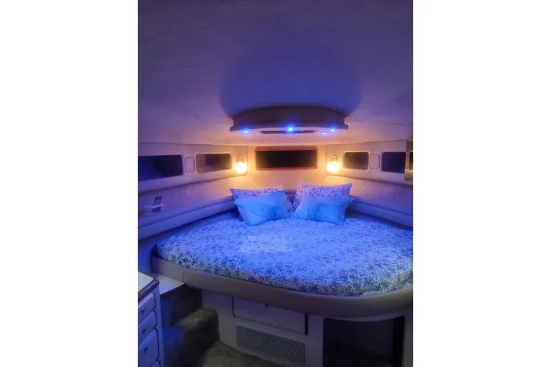 Slide: The Image of Cozy bedroom interior of 1996 Sea Ray 550 Sedan Bridge yacht with ambient lighting. - 9