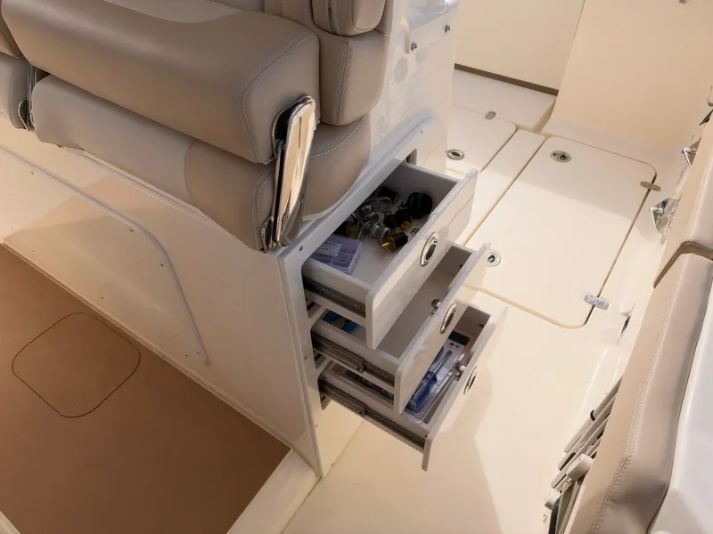 Slide: The Image of The 2027 Scout 330 LXF features open drawers with accessories on a clean deck. - 24