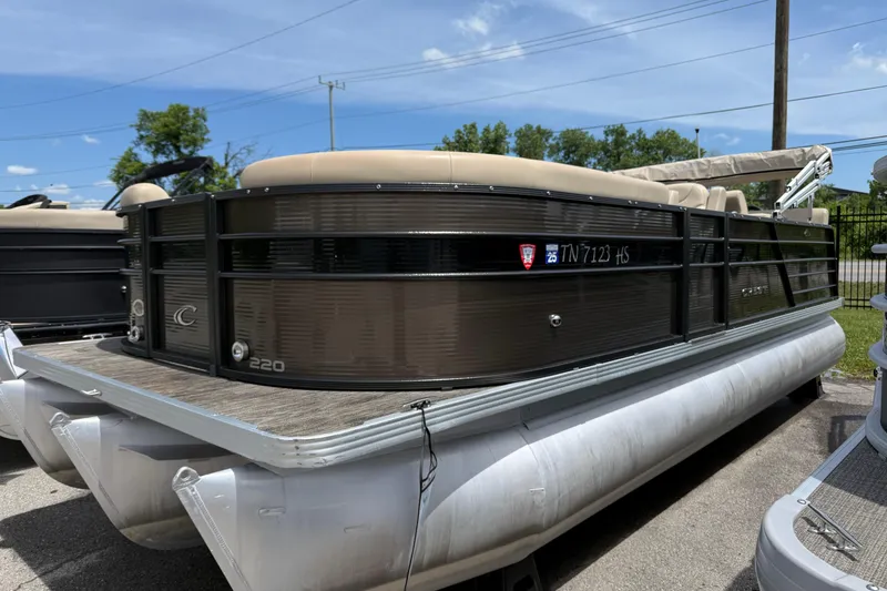 The Image of 2022 Crest Classic LX 220 pontoon boat parked on a sunny day. - 0