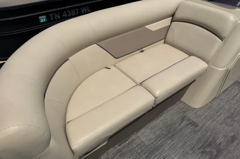 Slide: The Image of Beige seating on 2022 Crest Classic LX 220 pontoon boat, featuring plush upholstery. - 11