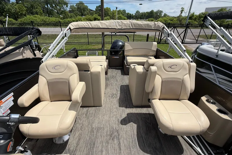 Slide: The Image of 2022 Crest Classic LX 220 pontoon boat with beige seating and canopy. - 13