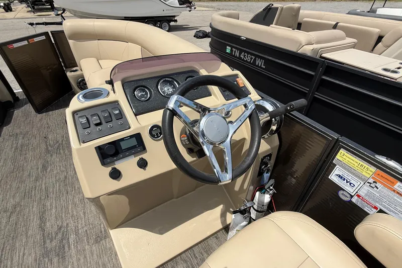 Slide: The Image of 2022 Crest Classic LX 220 boat dashboard with steering wheel and control panel. - 14
