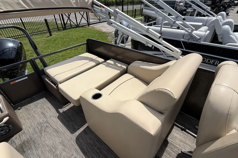 Slide: The Image of 2022 Crest Classic LX 220 boat interior with beige seating and cup holder. - 8