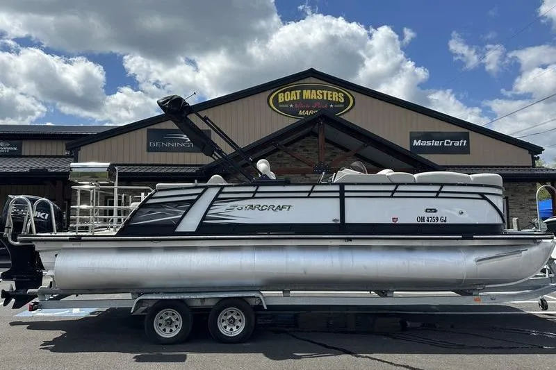 The Image of 2022 Starcraft SLS 3 pontoon boat on trailer at dealership. - 1