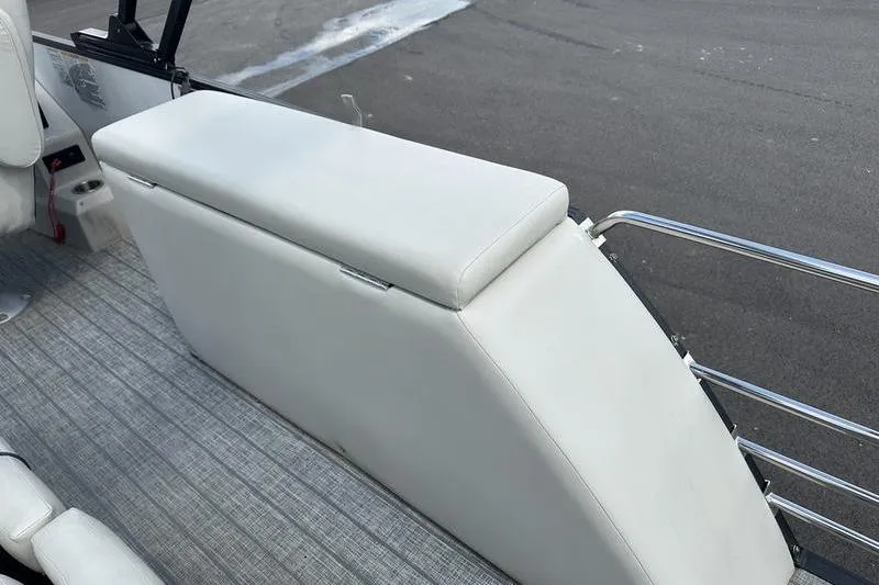 Slide: The Image of 2022 Starcraft SLS 3 boat interior with white cushioned seating and metal railing. - 15