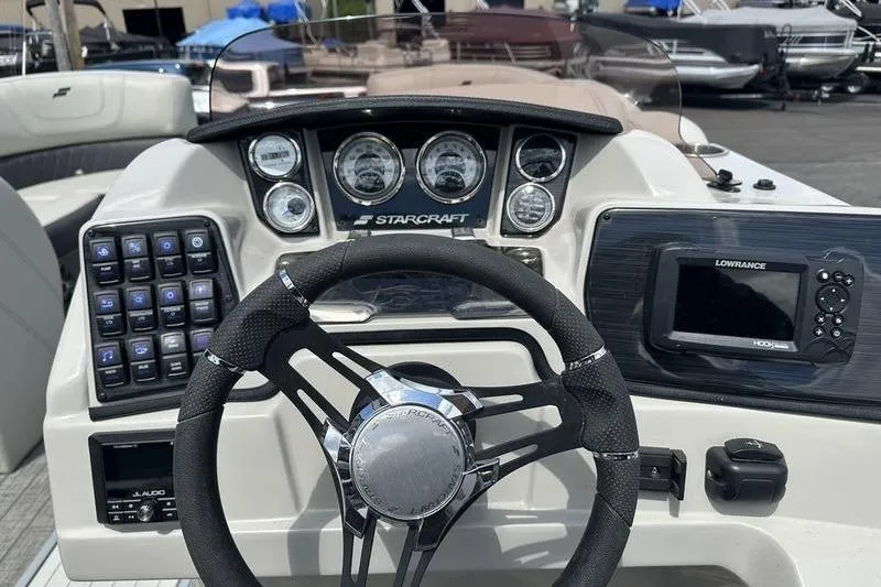 Slide: The Image of Cockpit of 2022 Starcraft SLS 3 boat with steering wheel and control panel. - 17