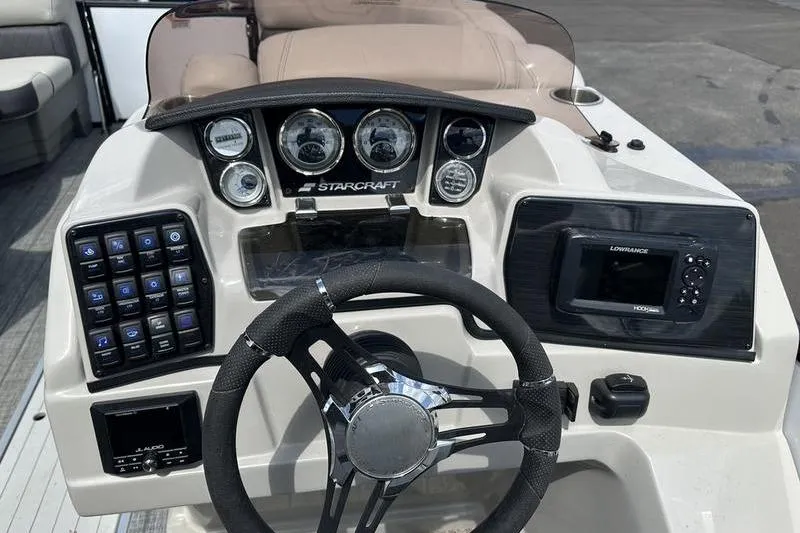 Slide: The Image of 2022 Starcraft SLS 3 boat dashboard with steering wheel and control panel. - 18