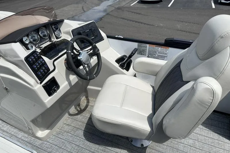 Slide: The Image of Captain's seat and dashboard of 2022 Starcraft SLS 3 boat, featuring modern controls and gauges. - 19